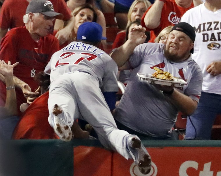 Image: Chicago Cubs shortstop Addison Russell dives into the crowd but is unable to catch a foul ball