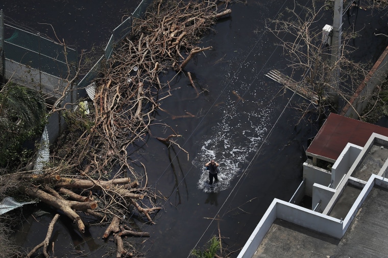 Image: A flooded street is seen as people deal with the aftermath of Hurricane Maria