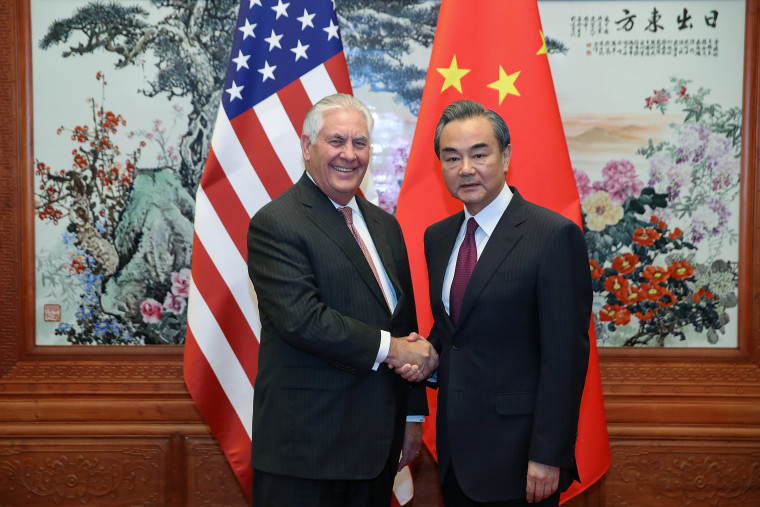 Image: U.S. Secretary of State Rex Tillerson (L) shakes hands with Chinese Foreign Minister Wang Yi (R) before their meeting at the Great Hall of the People in Beijing