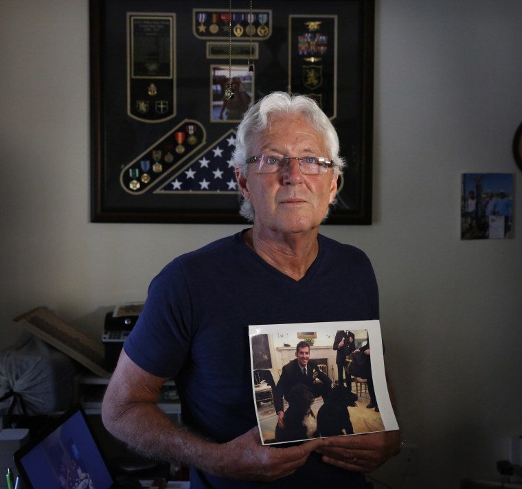 Image: William Owens holds a photo of his youngest son Navy SEAL William \"Ryan\" Owens in Lauderdale by the Sea, Florida.