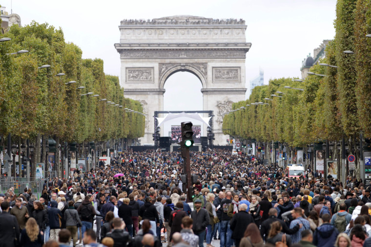 Image: People walk down the Champs Elysees avenue during a "car free" day