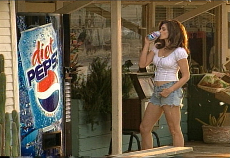 Here's Crawford in a re-creation of her iconic Pepsi ad, where she replaced the white bodysuit with a peasant top.