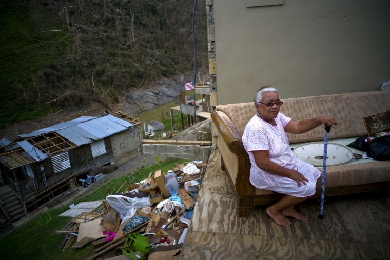 Juana Sortre Vazquez sits on her soaked couch in what remains of her home, destroyed by Hurricane Maria, in the San Lorenza neighborhood of Morovis, Puerto Rico, Saturday, Sept. 30, 2017.
