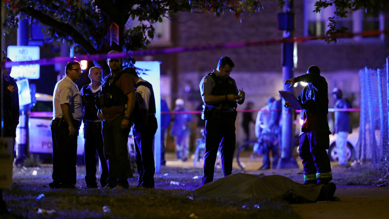 Police and fire officials inspect the scene of a fatal shooting on Sept. 29, 2017, in Chicago.