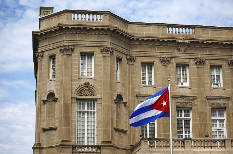 Image: Cuban national flag is seen raised over their new embassy in Washington