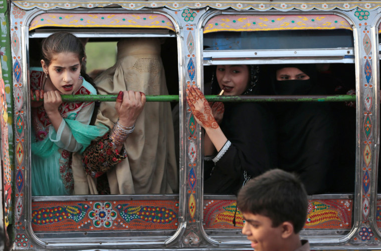 Image: Women ride in a van in Rawalpindi, Pakistan