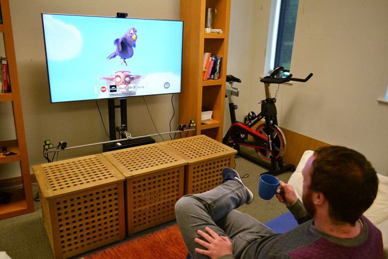 Image: Lancaster University researcher Christopher Clarke selects a channel to watch by using his mug as a remote control.