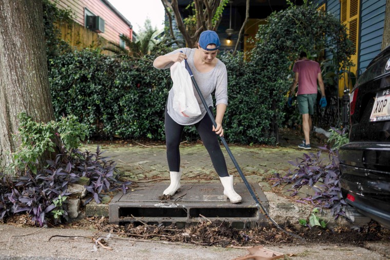 Image: Johnice Katz works to clear the storm drain in front of her home in preparation for Hurricane Nate in New Orleans on Oct. 07, 2017.