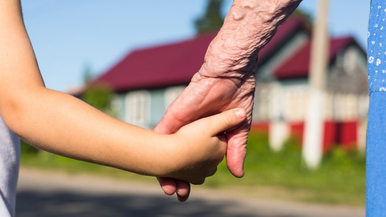 Hands of the old woman and child.