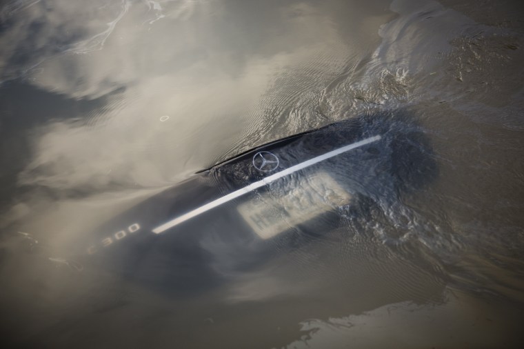 Image: The submerged trunk of a Mercedes in a west Houston neighborhood flooded as waters overtopped the Addicks Reservoir.