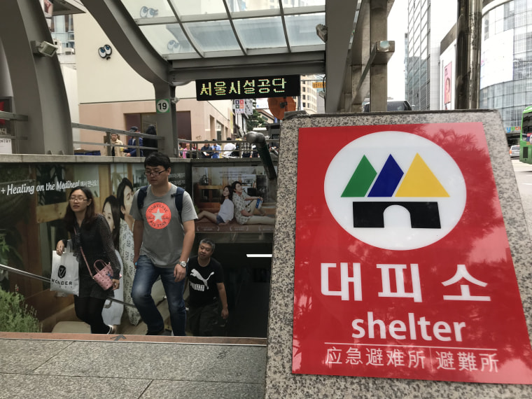 Image: South Koreans emerge from an underground shopping center