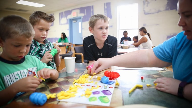 Ayden, 9, plays a board game with other children at the Children's Home Network.