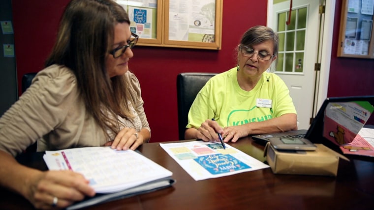 Tena Randecker, right, walks Rebecca Schuckert, 54, through programs available to her grandchildren. Randecker is raising her own grandchildren and now helps other grandparents as a Kinship Navigator with the Children's Home Network. "We need the caregivers to know they aren't alone," she said.