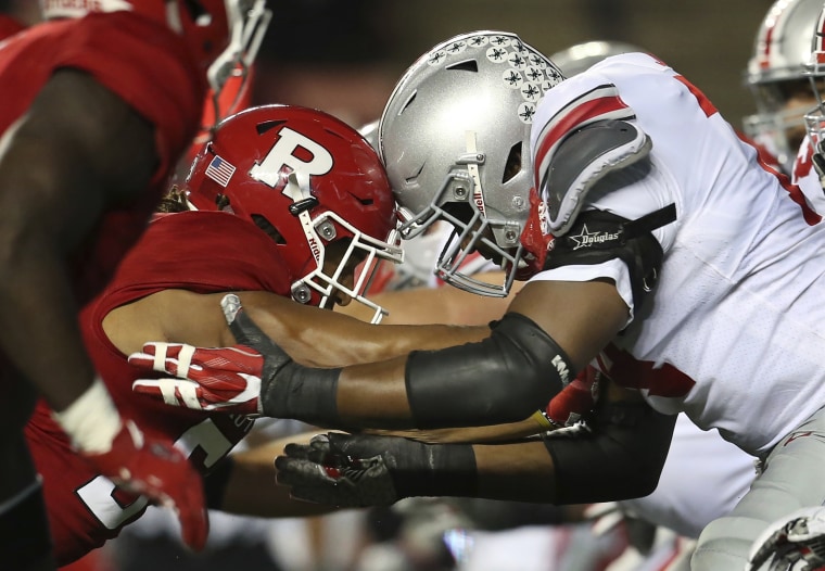 Ohio State offensive and Rutgers defensive linemen go helmet-to-helmet during a college football game on Sept. 30 in Piscataway, New Jersey.