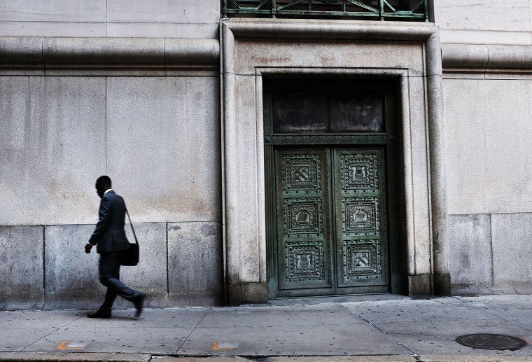 Image: A man walks through Manhattan's financial district
