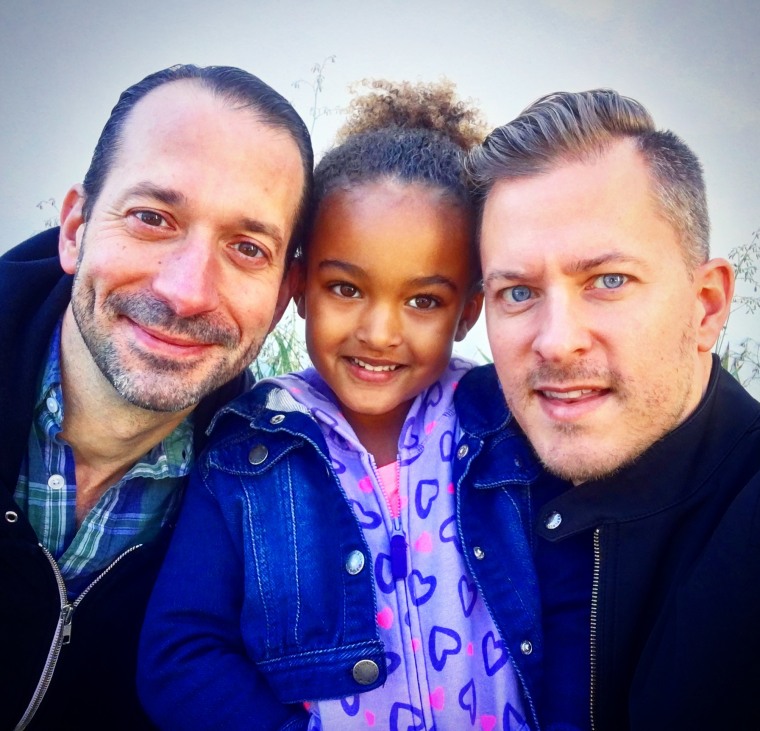 Michael Anderson (right) with his husband Jeff Binder (left) and their daughter Annika (center). 