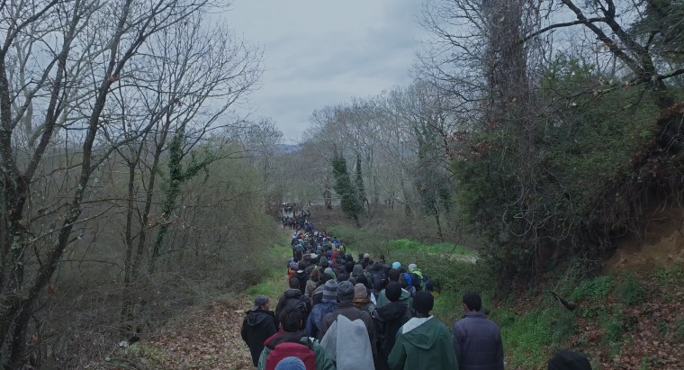 Refugees walking near Idomeni Camp, Greece in "Human Flow," an Amazon Studios release.