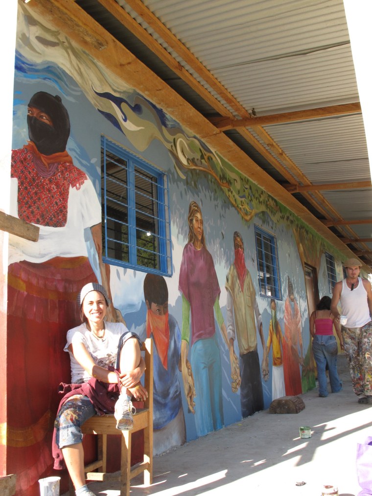 Artist Katie Yamasaki working on a mural.