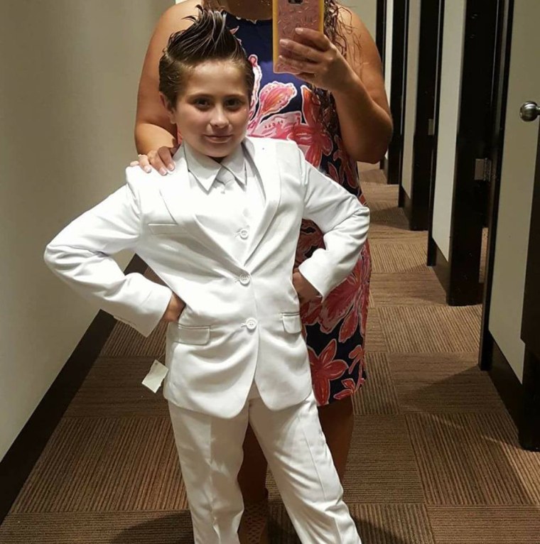 Image: Cady Mansell in a white pants suit, which she hoped to wear to her First Holy Communion but was not allowed to do so