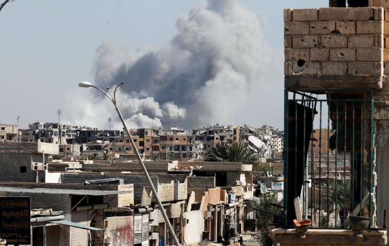 Image: Smoke rises near the sports stadium in Raqqa