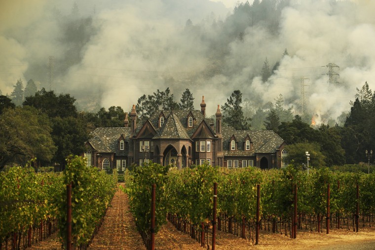 Image: A wildfire burns behind a winery