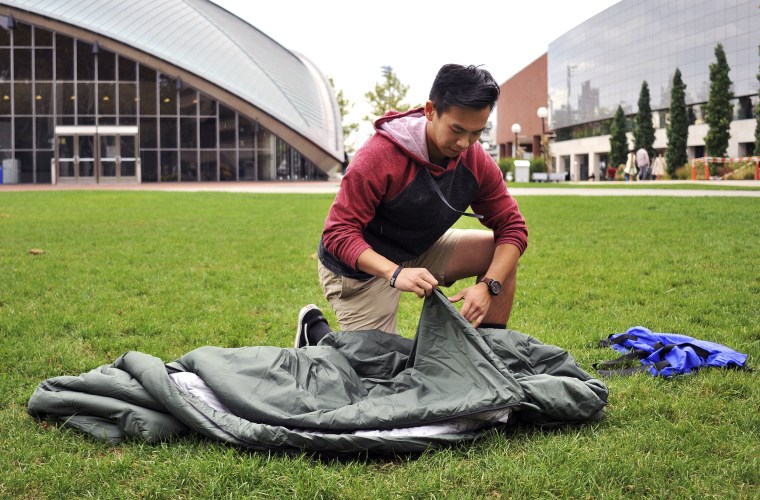 Image: Vick Liu unrolls his TravlerPack, a lightweight sleeping bag, outside the Kresge Auditorium at the Massachusetts Institute of Technology in Cambridge, Massachusetts, Oct. 6, 2017.