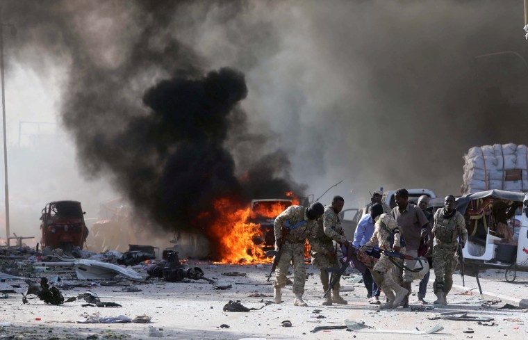 Image: Somali Armed Forces evacuate their injured colleague, from the scene of an explosion in Mogadishu