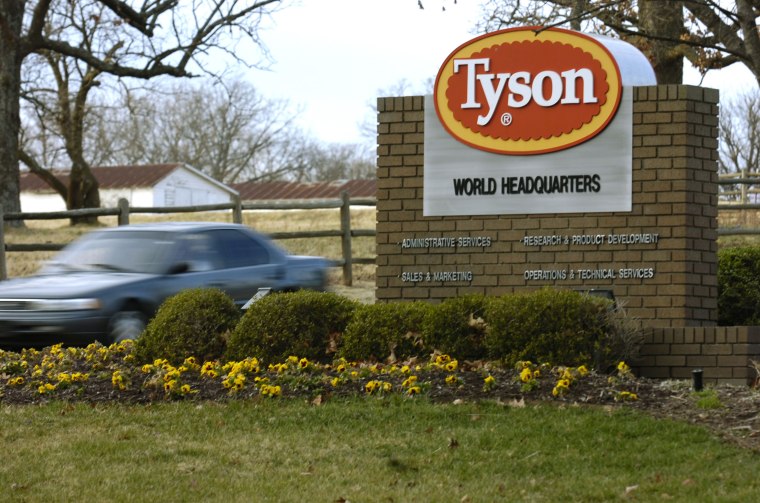 Image: A car passes in front of a Tyson Foods Inc., sign at Tyson headquarters