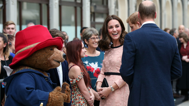 Britain's Prince William, back to camera, Kate, Duchess of Cambridge and Prince Harry meet Paddington Bear at Paddington Station in London, Monday Oct. 16, 2017