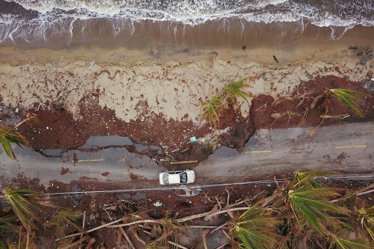 Image: A car drives on a damaged road in the aftermath of Hurricane Maria in Humacao