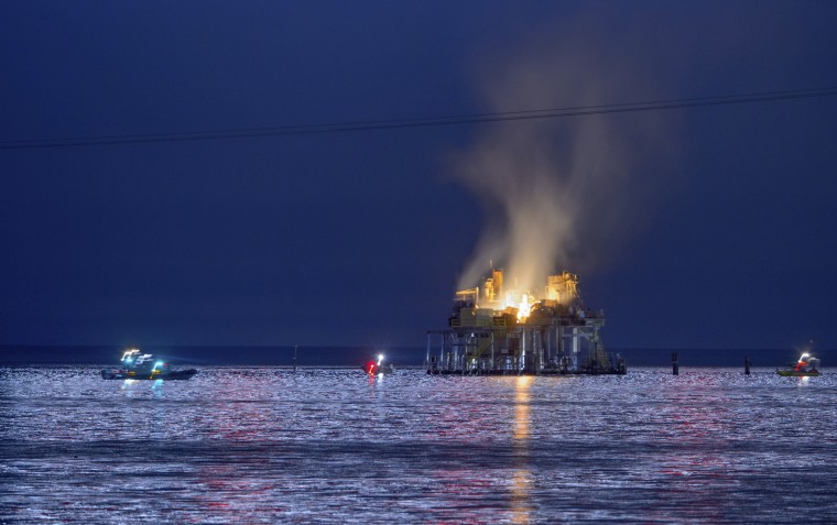 Authorities respond to an oil rig explosion in Lake Pontchartrain, off Kenner, La., on Sunday, Oct. 15, 2017.