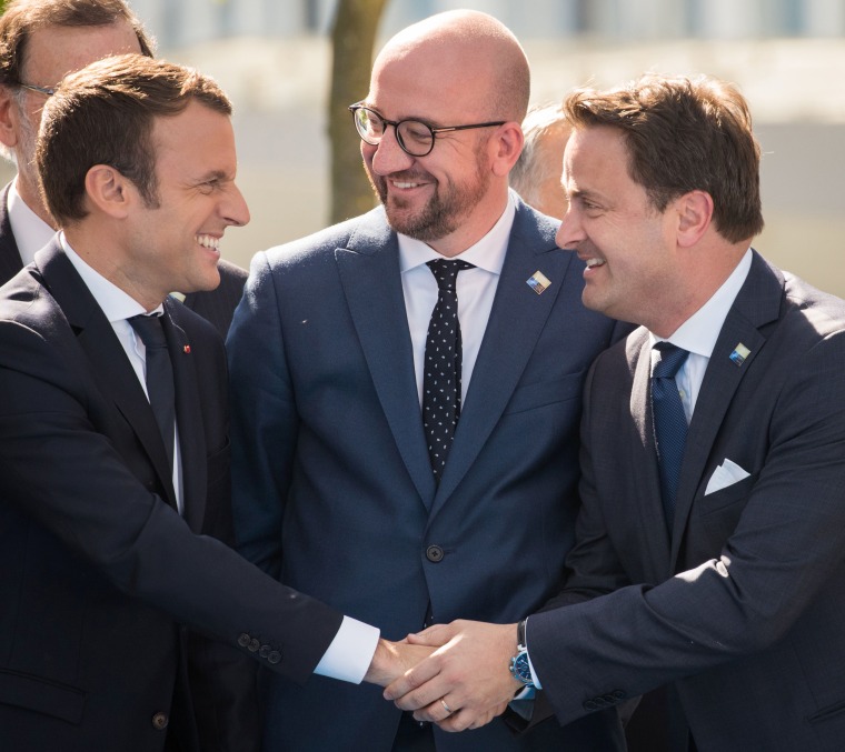 Image: French President Emmanuel Macron, left, with Luxembourg Prime Minister Xavier Bettel, right, and Belgian Prime Minister Charles Michel