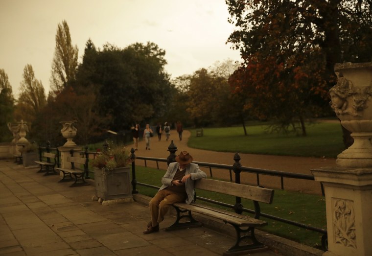 Image: Hyde Park is bathed in a dull sepia light from the sky in London