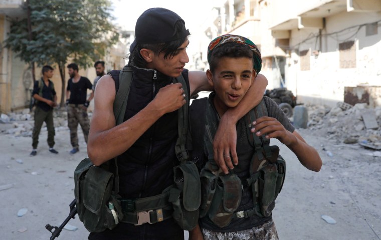 Image: Teen fighters of Syrian Democratic Forces joke each other in Raqqa