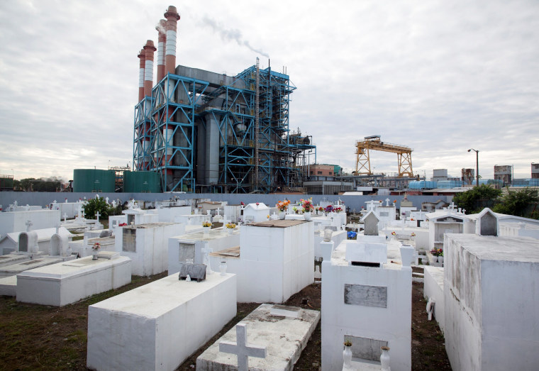 Image: FILE PHOTO: The power station Central Palo Seco of PREPA is seen behind a cemetery in San Juan