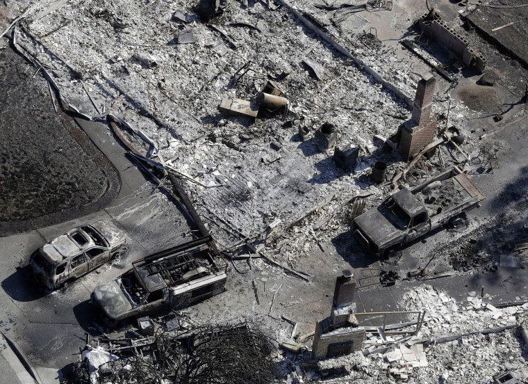Image: California residents return home to inspect destroyed homes and try to find remaining possessions