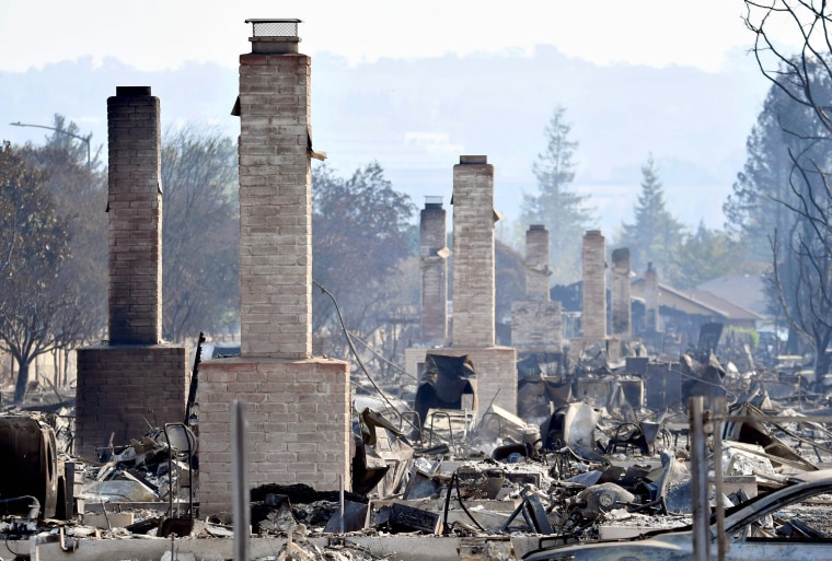Image: California residents return home to inspect destroyed homes and try to find remaining possessions