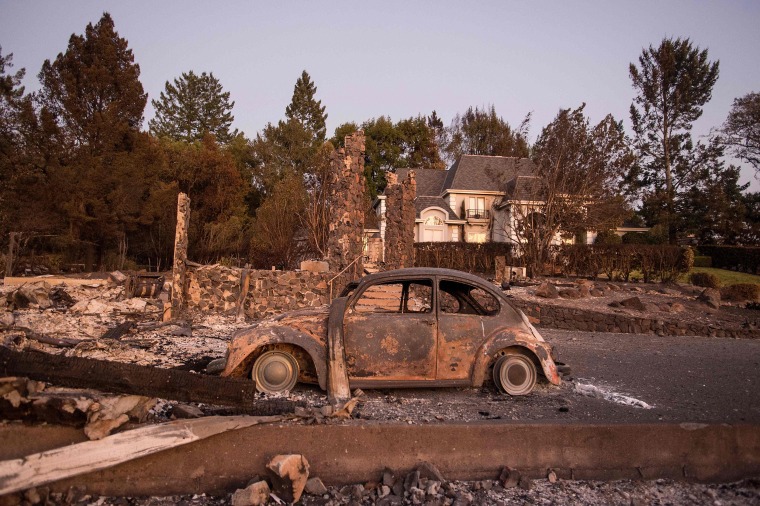 Image: California residents return home to inspect destroyed homes and try to find remaining possessions
