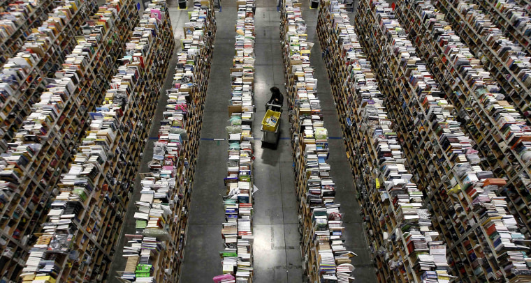 Image: Worker gathers items for delivery at Amazon's distribution center in Phoenix