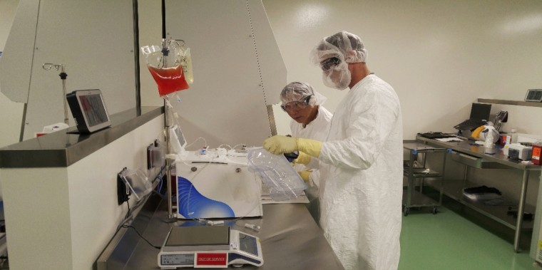 Cell therapy specialists prepare blood cells from a patient to be engineered in the lab to fight cancer at Kite Pharma, the company that developed the Yescarta therapy, in El Segundo, California.