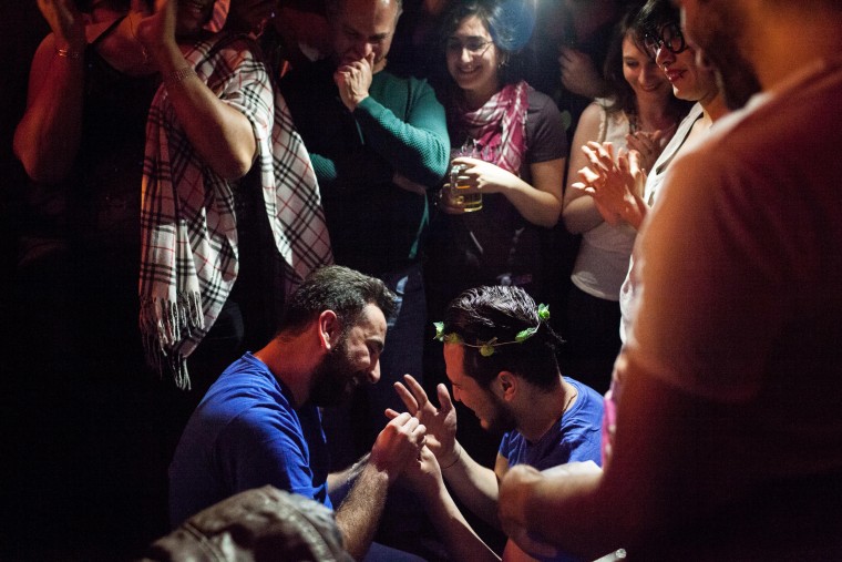 Image: Nader, left, puts a ring on Omar's finger after proposing during Omar's birthday party in Istanbul