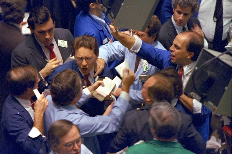 Image: Traders work on the floor of the New York Stock Exchange as panic selling swept Wall Street