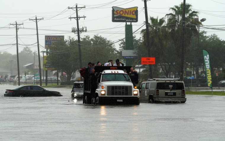 Image: People evacuate by dump truck from the Hurricane Harvey floodwaters in Dickinson, Texas, Aug. 28, 2017.