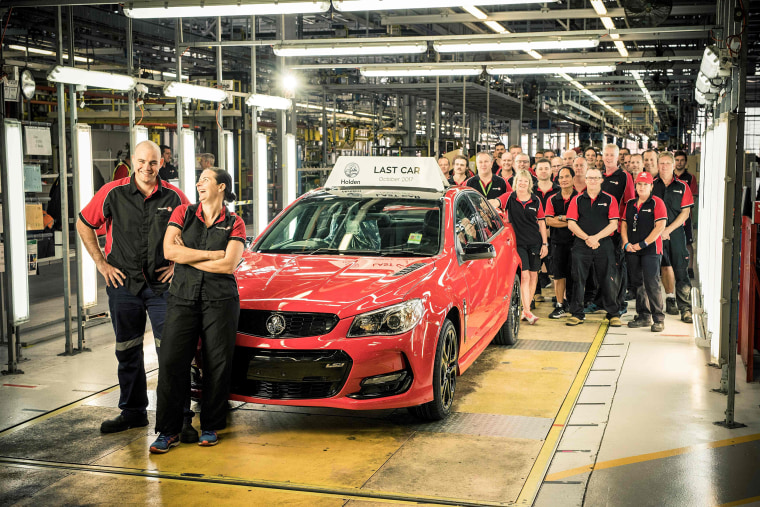 Image: Holden Auto workers with the last car to roll off their production line