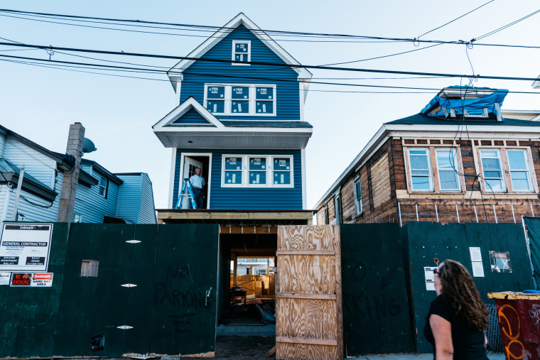 Image: Alison Kase speaks with her uncle as he works on a home damaged by Hurricane Sandy