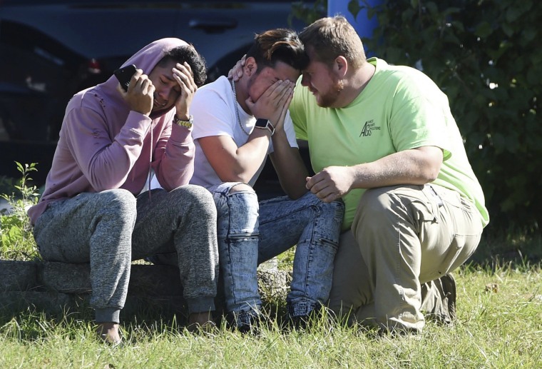 Image: Workers from the Advanced Granite Solutions company console each other