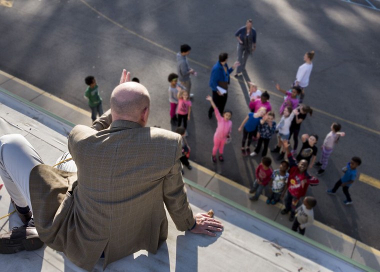 Principal Vercellino waving to his students.
