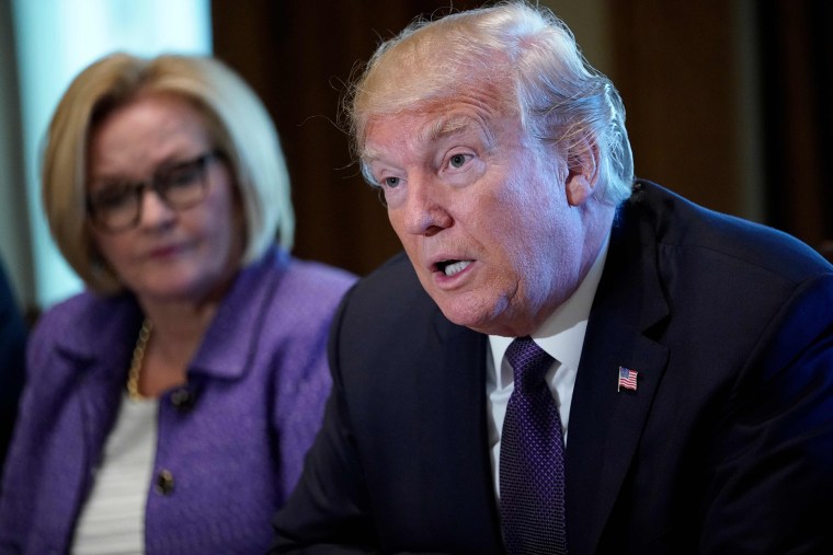 Image: US President Donald Trump speaks next to Senator Claire McCaskill