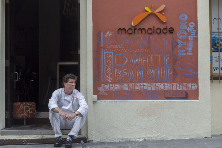 Marmalade Chef, Peter Schintler, sits outside his restaurant in the neighborhood of Old San Juan on Wednesday, Oct. 18, 2017 in San Juan, Puerto Rico. Businesses and restaurants in tourist areas of San Juan are operating on generators and are struggling nearly a month after hurricane Maria ravaged the Island of Puerto Rico.