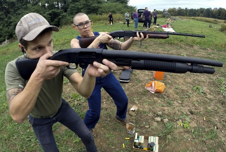 Jon Falstaff, left, shows Emily Lynch how to properly stand and hold a shotgun during an Oct. 8 training session for the Trigger Warning Queer & Trans Gun Club in Victor, N.Y.
